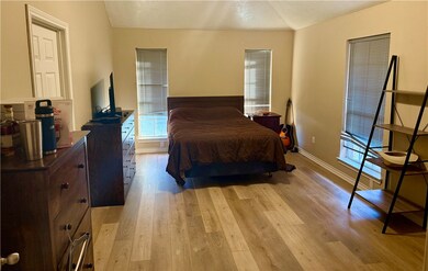 Bedroom featuring light wood-type flooring and bas