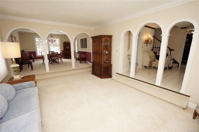 Unique archways frame this inviting sunken living 