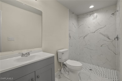 Bathroom with marble finish floors, vanity, a marb
