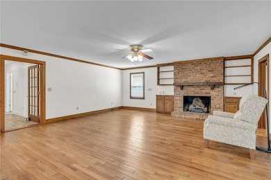 Large open den with wood burning fireplace.