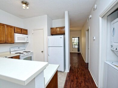 Kitchen featuring brown cabinets, white appliance