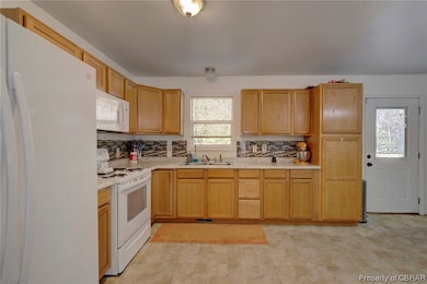 Kitchen featuring a wealth of natural light, white