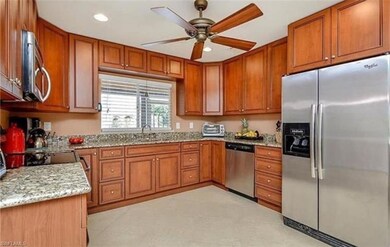 Kitchen featuring ceiling fan, brown cabinets, and