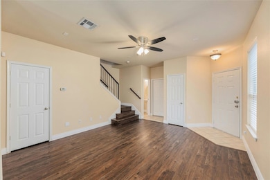 Entryway with wood finished floors, ceiling fan, 