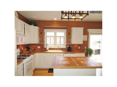 Pretty as a Picture White Kitchen with Hardwood Fl