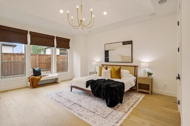 Bedroom featuring recessed lighting, light wood-type flooring, and a chandelier