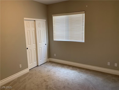 Unfurnished bedroom featuring light colored carpet and a closet