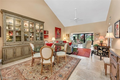 Dining space with high vaulted ceiling and a ceili