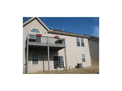 Back elevation, deck off kitchen, patio off family