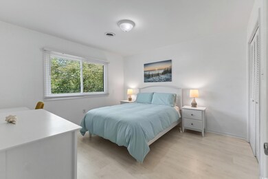 Bedroom featuring baseboards, light wood finished 