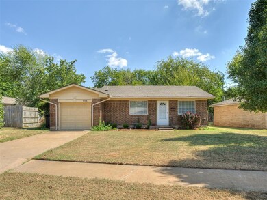 Single story home with a front yard and a garage
