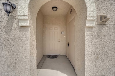 View of exterior entry featuring stucco siding