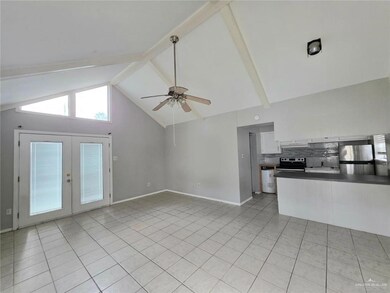 Unfurnished living room with french doors, a ceiling fan, light tile patterned floors, beamed ceiling, and high vaulted ceiling