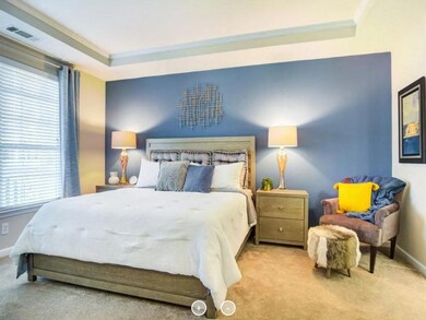 Bedroom featuring carpet, ornamental molding, and 