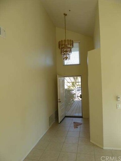 Entry showing security door with chandelier overhe