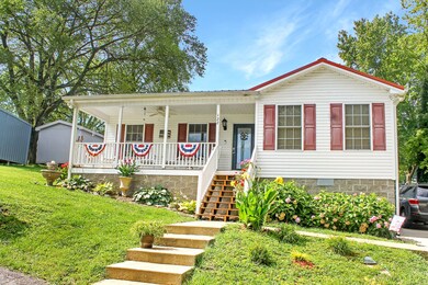 Low maintenance home with vinyl siding and gorgeous landscaping.