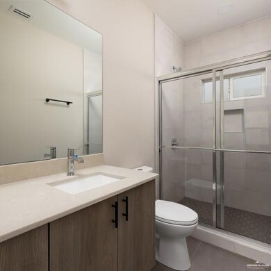 Full bath featuring vanity, a stall shower, and tile patterned floors