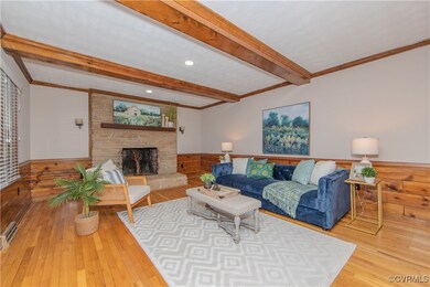 Living room featuring a fireplace, beamed ceiling,