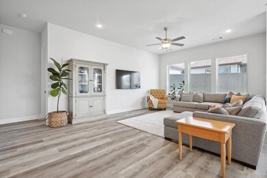 Living room featuring ceiling fan and light hardwo