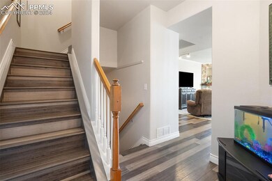 Stairway featuring hardwood / wood-style floors