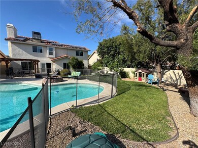 View of pool featuring mature trees, a patio, a ya