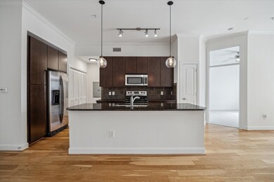 Open kitchen w custom modern cabinets, granite cou