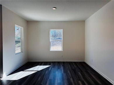 Unfurnished room with dark hardwood / wood-style f