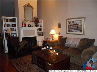 Living room has fireplace, bookcases and vaulted c