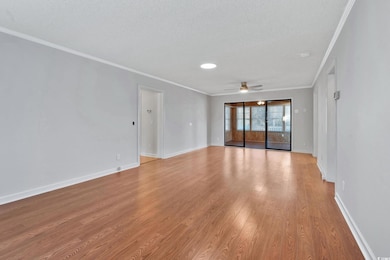 Spare room featuring crown molding, ceiling fan, l