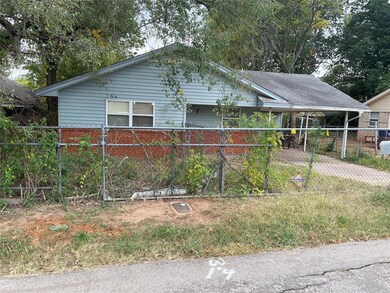 Front view, yard is fenced and has a gate