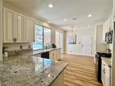 Kitchen with black stainless steel appliances, a c