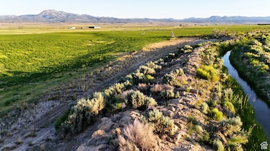 View of mountain background with rural landscape and a nearby body of water