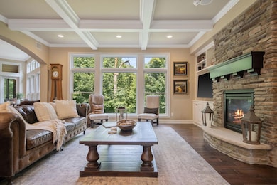 The wall of windows from the main level living room offers breathtaking westerly views over the backyard.  Put on the fireplace and relax this fall!