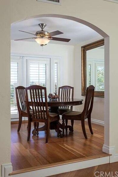 Elegant dining room with wood floors, arched doorw