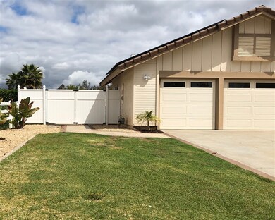 Double gate to concrete side yard area.