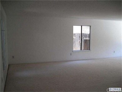 Living room with neutral paint and carpet.