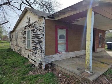 View of side of home featuring fence