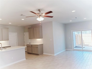 Kitchen featuring recessed lighting, gray cabinet