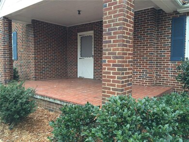 Left exterior covered porch with entrance into living room