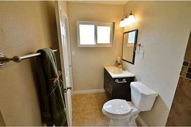 Remodeled bathroom with new vanity and tile.