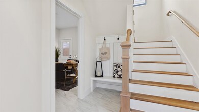 As you step into your bright, modern entryway with