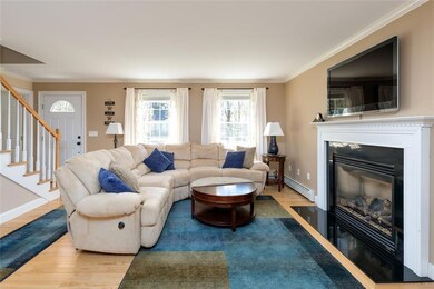 Living room with gas fireplace, wood...