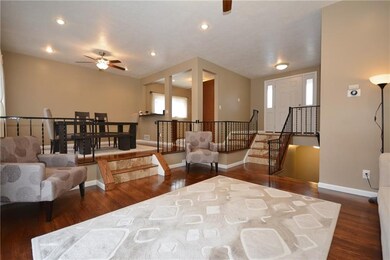The living room has gleaming hardwood floor, reces