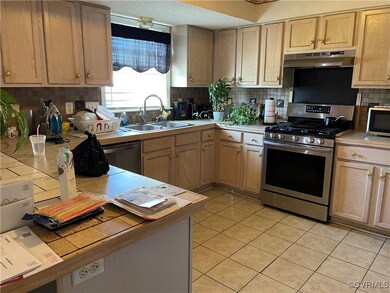 Kitchen with tile countertops, light tile patterne