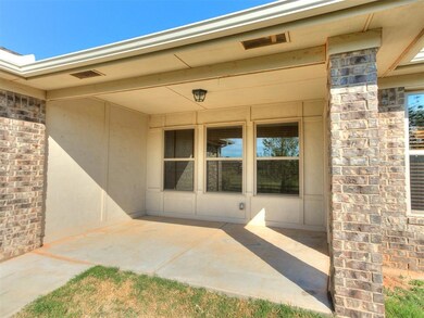 View of exterior entry with a patio area