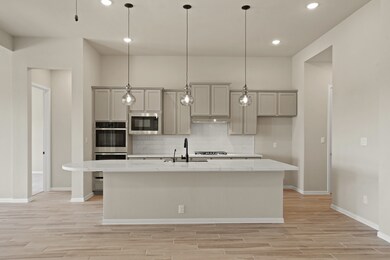 Kitchen with vast island & pendant lights