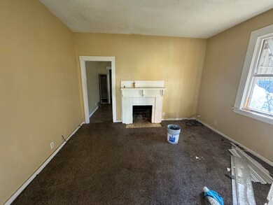 Unfurnished living room featuring a tile fireplace