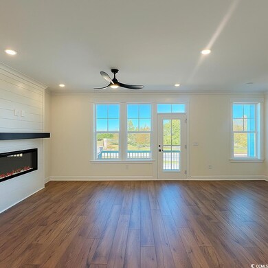 Unfurnished living room with healthy amount of natural light, ornamental molding, dark wood finished floors, recessed lighting, and a ceiling fan