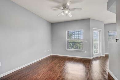 Empty room featuring dark wood finished floors, c