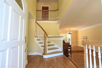 A Welcoming Formal Entry with a Winding Staircase,